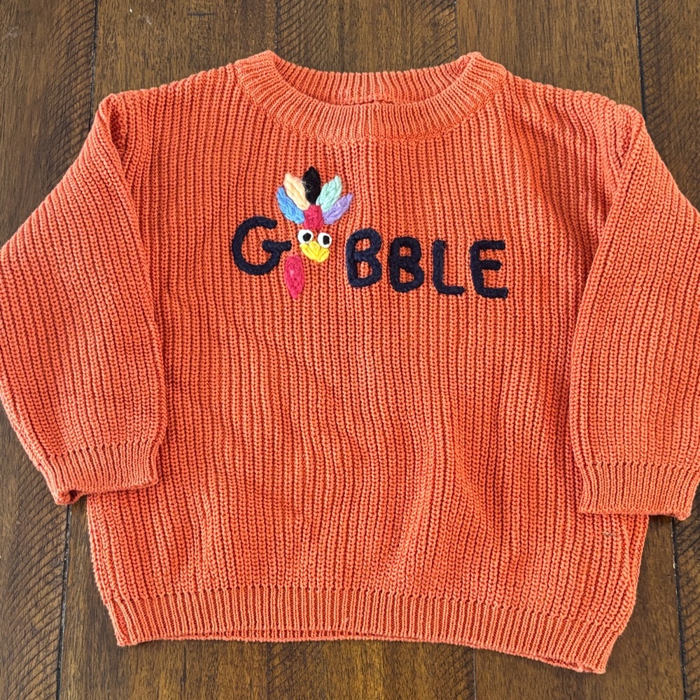 Orange Sweater with Embroidered Design